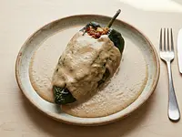 Chiles Rellenos de Tocino y Sesos en Salsa de Avellana